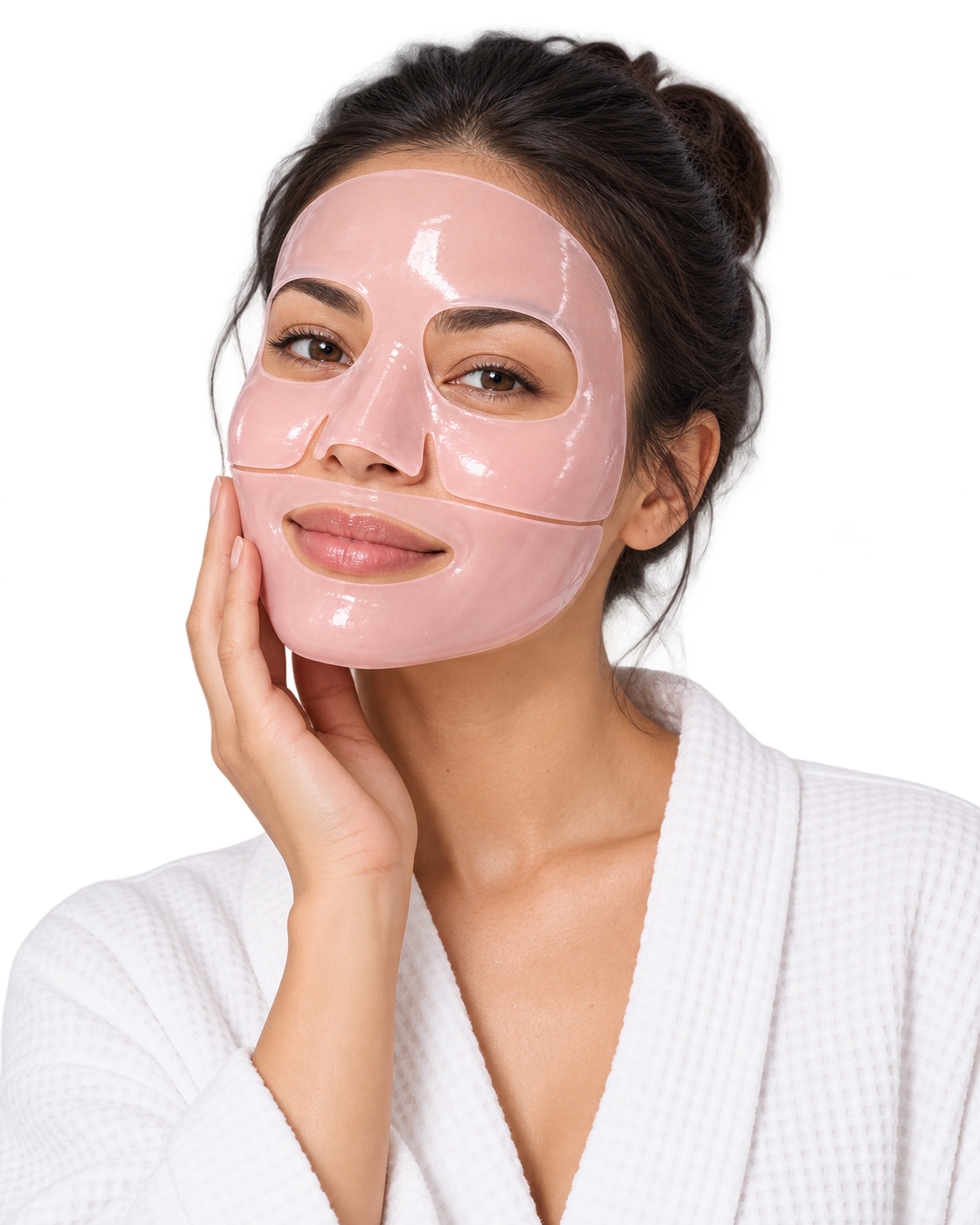 Woman in a white waffle robe wearing a two-piece pink hydrogel mask